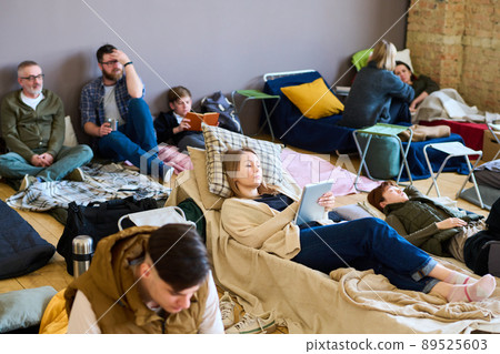 Young female refugee with tablet looking through online news or video 89525603