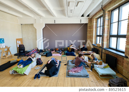 Several sleeping places with temporarily homeless people in spacious room 89525615