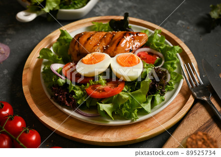 Tasty healthy salad with boiled egg and roasted grilled chicken breast Tasty healthy salad with boiled egg and roasted grilled chicken breast 89525734