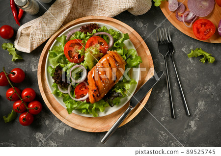 Fresh salad with roasted chicken breast on a wooden board Fresh salad with roasted chicken breast on a wooden board 89525745