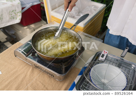 Churros are fried in boiling oil in a frying pan. concept COOKING background . Churros are fried in boiling oil in a frying pan. concept COOKING background . 89526164