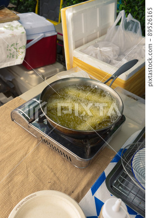 Churros are fried in boiling oil in a frying pan. concept COOKING background . Churros are fried in boiling oil in a frying pan. concept COOKING background . 89526165