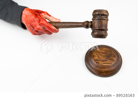 Female judge with bloody hands beats the gavel on a white background. Female judge with bloody hands beats the gavel on a white background. 89528163