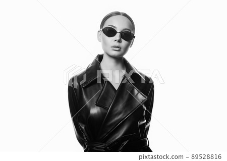 fashion black and white portrait of Beautiful woman in sunglasses and leather trench coat fashion black and white portrait of Beautiful woman in sunglasses and leather trench coat 89528816