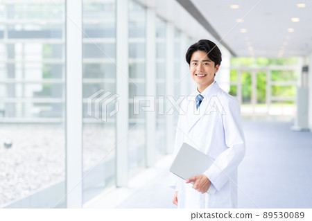 A young man in a white coat 89530089