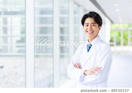 A young man in a white coat A young man in a white coat 89530157