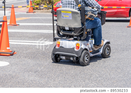A person riding an electric senior car A person riding an electric senior car 89530233