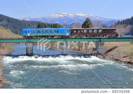 Akita inland railcar crossing the Komata River bridge Akita inland railcar crossing the Komata River bridge 89530266