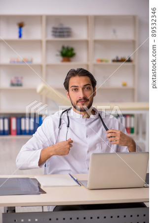 Young male doctor working in the clinic Young male doctor working in the clinic 89532346