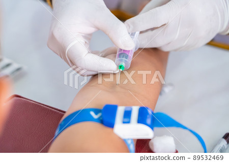 Nurse collecting a blood from patient in hospital 89532469