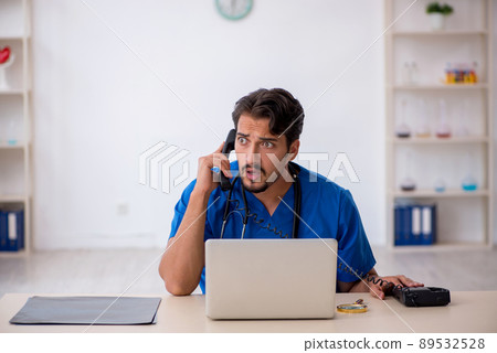 Young male doctor working in the clinic Young male doctor working in the clinic 89532528