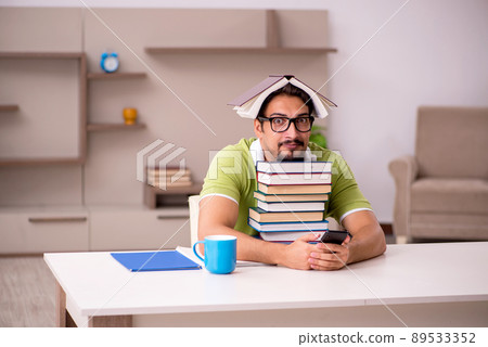 Young male student studying at home 89533352