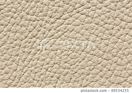 Light beige leather texture with uneven surface. Light beige leather texture with uneven surface. 89534255