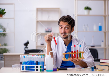 Young male chemist working at the lab 89534369