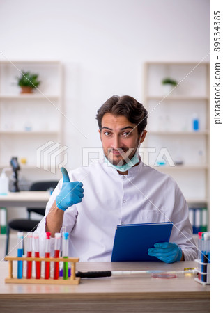Young male chemist working at the lab 89534385