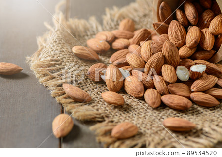 Almonds nut on wood background. They are highly nutritious and rich in healthy fats 89534520