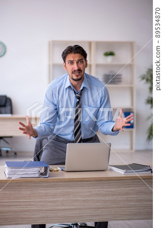 Young male employee working in the office Young male employee working in the office 89534870