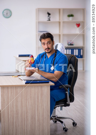 Young male doctor cardiologist working in the clinic Young male doctor cardiologist working in the clinic 89534929
