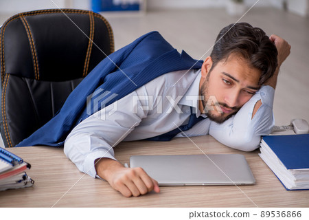 Young male employee extremely tired in the office 89536866