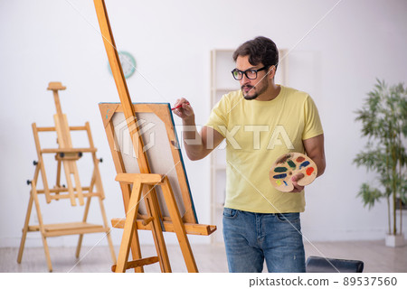 Young man enjoying painting at home Young man enjoying painting at home 89537560