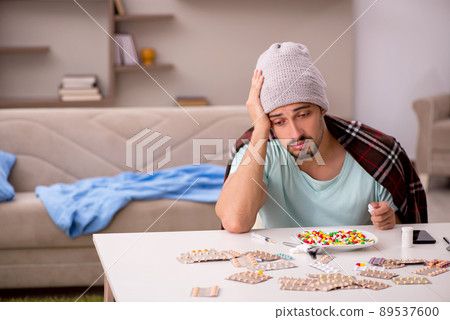 Young sick man suffering at home Young sick man suffering at home 89537600