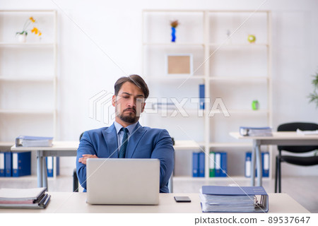 Young male employee working in the office Young male employee working in the office 89537647