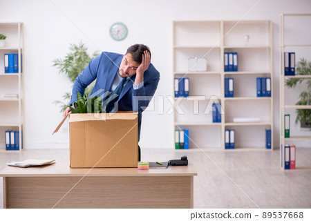Young male employee in business relocation concept 89537668