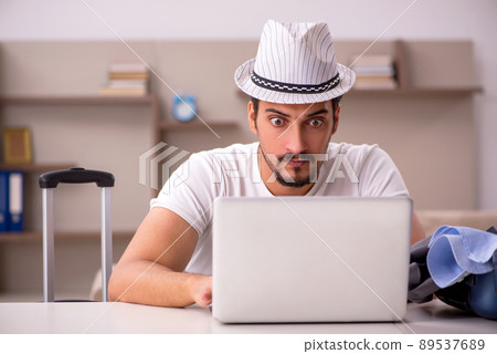 Young man preparing for trip at home Young man preparing for trip at home 89537689