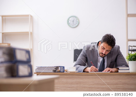 Young male employee working in the office Young male employee working in the office 89538140