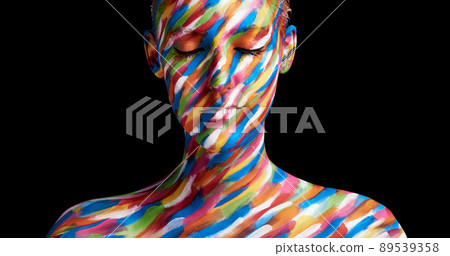 In living colour. Cropped shot of a young woman posing with paint on her face. In living colour. Cropped shot of a young woman posing with paint on her face. 89539358