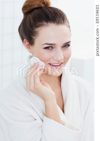 Subtly beautiful. A gorgeous teenage girl cleaning her skin. 89539685