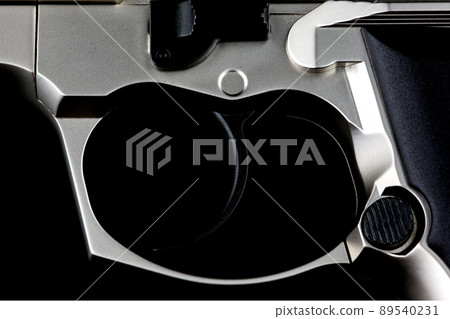 Semi Automatic Pistol Trigger Section on a Black Background 89540231