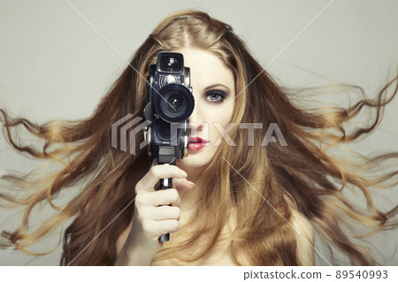 Portrait of a beautiful woman with the camera. Fashion photo Portrait of a beautiful woman with the camera. Fashion photo 89540993
