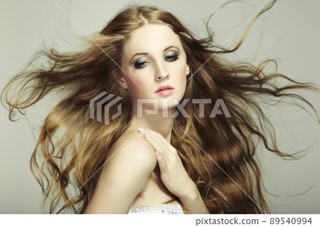 Portrait of young beautiful woman with long flowing hair. Fashion photo Portrait of young beautiful woman with long flowing hair. Fashion photo 89540994