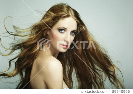 Portrait of young beautiful woman with long flowing hair Portrait of young beautiful woman with long flowing hair 89540996