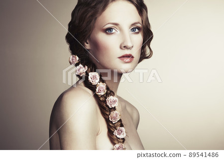 Portrait of a beautiful woman with flowers in her hair Portrait of a beautiful woman with flowers in her hair 89541486