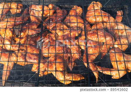 Grilled chicken wings.cooking fry shish kebab,BBQ, barbecue, shashlik or meat on coals. Cooking meat in the grill on skewers in nature in the summer on a picnic. Pork on the grill 89541602