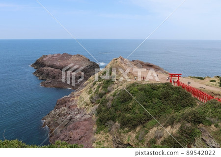 The approach to the Motonosumi Shrine in Nagato City, Yamaguchi Prefecture, Japan, followed by the red torii gate and the Sea of Japan 89542022