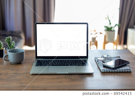 mock up empty screen computer on wood desk, Laptop computer with blank white screen on table in office.with clipping path 89542415