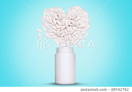 Advertising vitamins and dietary supplements. A white jar with scattered pills in the form of a heart. Blue background. Mock up, copy space. The concept of treatment of heart diseases Advertising vitamins and dietary supplements. A white jar with scattered pills in the form of a heart. Blue background. Mock up, copy space. The concept of treatment of heart diseases 89542762