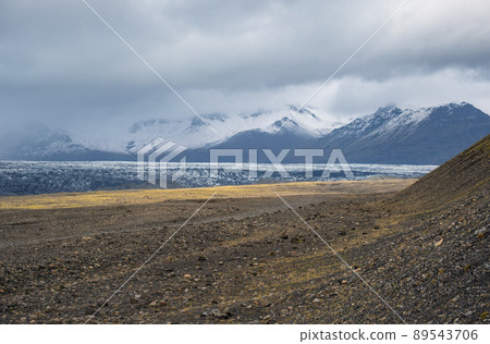 Iceland autumn tundra landscape near Haoldukvisl glacier, Iceland. Glacier tongue slides from the Vatnajokull icecap or Vatna Glacier near subglacial Esjufjoll volcano. Not far from Iceland Ring Road. 89543706