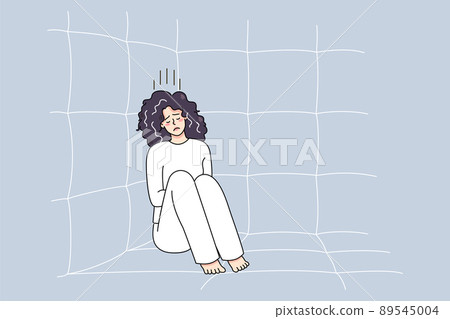 Sick woman in straitjacket sit in madhouse  89545004