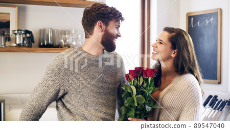 Beautiful roses for my beautiful wife. Shot of a young man surprising his wife with a bunch of roses at home. Beautiful roses for my beautiful wife. Shot of a young man surprising his wife with a bunch of roses at home. 89547040