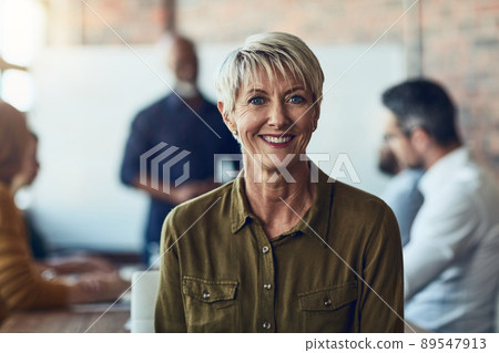 I'm happy to lend my expertise. Cropped portrait of a mature businesswoman sitting in the boardroom during a presentation. 89547913