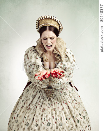 Ruling can be bloody business. Studio shot of a queen with blood on her hands. Ruling can be bloody business. Studio shot of a queen with blood on her hands. 89548577