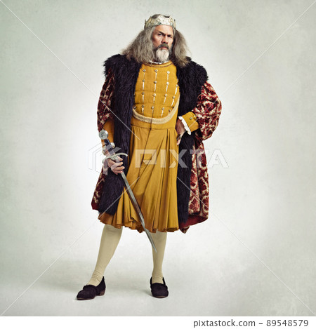 I'm honorable...to a point. Studio shot of a richly garbed king holding a sword. I'm honorable...to a point. Studio shot of a richly garbed king holding a sword. 89548579