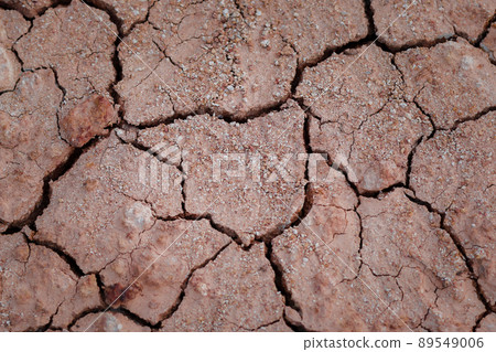 Top view cracked red soil. Picture of natural disaster. Drought land, global warming and deforestation. Image of brown soil texture, close up. Top view cracked red soil. Picture of natural disaster. Drought land, global warming and deforestation. Image of brown soil texture, close up. 89549006