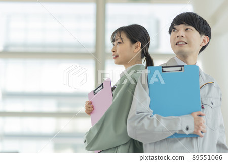 Young male and female construction engineers 89551066