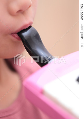 Girl playing keyboard harmonica 89551193