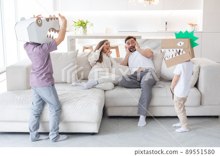 Family playing dinosaurs at home 89551580